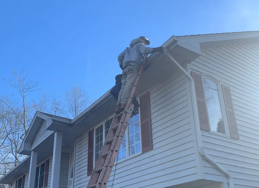 Gutter cleaning and maintenance being performed by Maple Heights Power Washing in Maple Heights